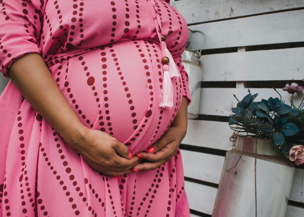 women's pink and red long-sleeved maternity dress