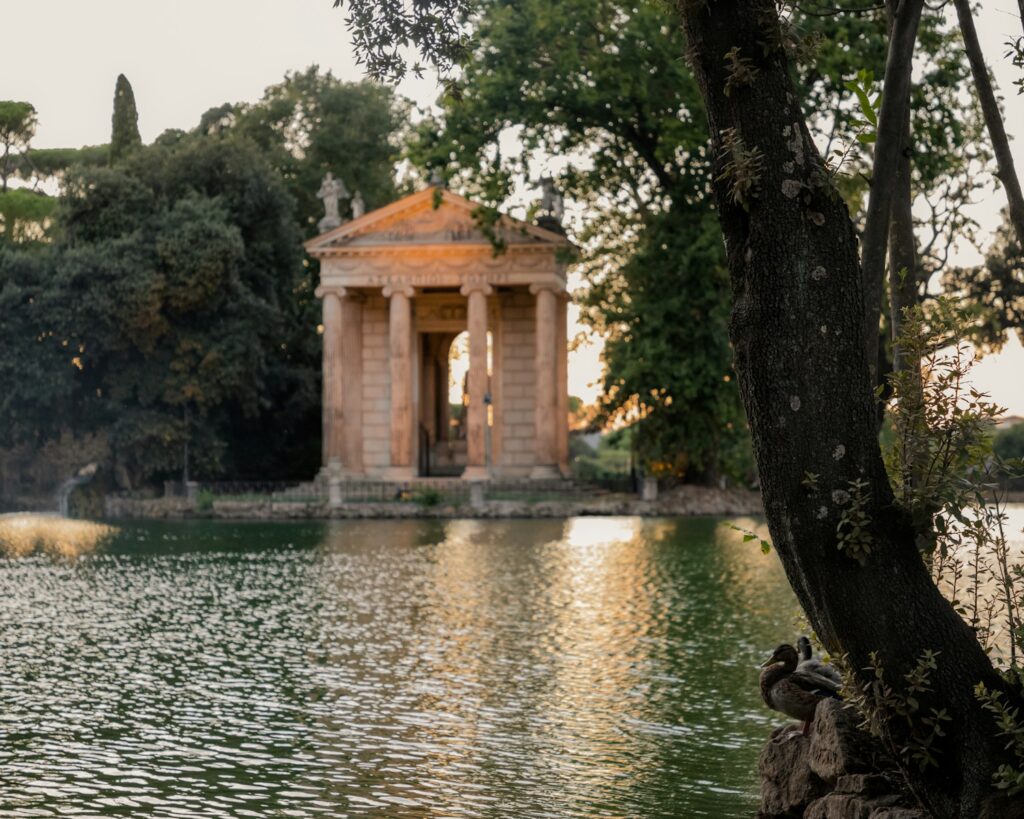a pond with a gazebo in the middle of it