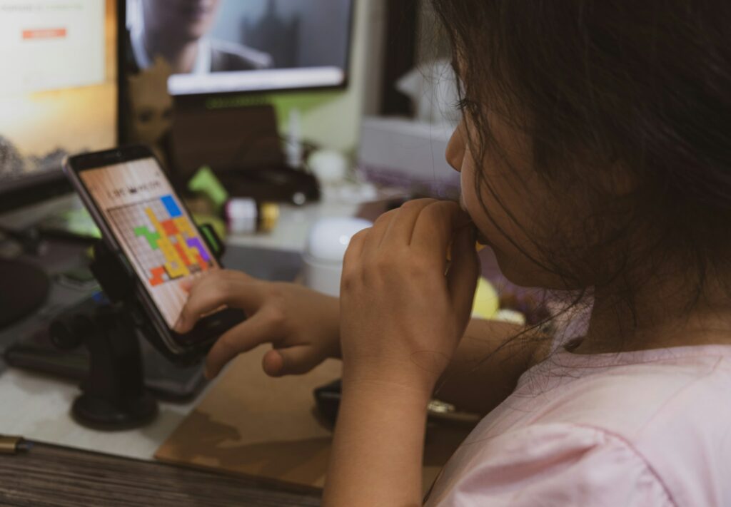 woman in pink shirt holding smartphone