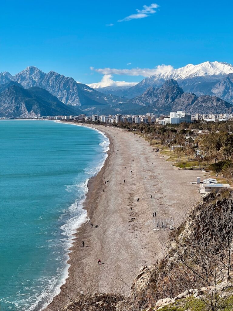a view of a beach with mountains in the background