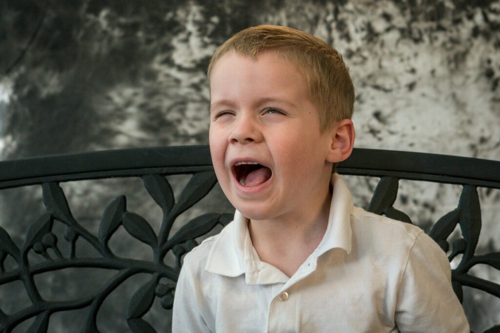 shallow focus photo of boy in white button-up shirt